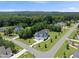 Aerial view of a neighborhood showcasing modern homes with lush green landscapes and mature trees at 20 Delia Ln, Pittsboro, NC 27312