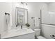 Bright bathroom featuring a sleek vanity, modern fixtures, and tiled shower for a clean and updated feel at 20 Delia Ln, Pittsboro, NC 27312