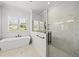 Contemporary bathroom featuring a walk-in shower, soaking tub, and marble accents for a luxurious feel at 20 Delia Ln, Pittsboro, NC 27312