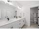 Bright bathroom featuring double sink vanity, sleek fixtures, and elegant tile flooring at 20 Delia Ln, Pittsboro, NC 27312