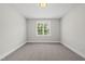Comfortable bedroom features soft carpeting and a sunlit window, perfect for a relaxing retreat at 20 Delia Ln, Pittsboro, NC 27312