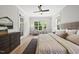 Bright bedroom featuring a large window with seating area, ceiling fan, and hardwood floors at 20 Delia Ln, Pittsboro, NC 27312