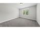 Bright, carpeted bedroom with ample natural light, providing a comfortable and serene living space at 20 Delia Ln, Pittsboro, NC 27312