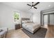 Comfortable bedroom with a neutral color palette, large window, and a geometric patterned rug at 20 Delia Ln, Pittsboro, NC 27312