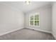 Bright, empty bedroom with plush carpet, a large window with shutters, and neutral paint at 20 Delia Ln, Pittsboro, NC 27312