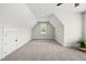 An empty bonus room with carpet, angled ceilings and bright light from the windows at 20 Delia Ln, Pittsboro, NC 27312