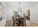 The dining room features a stylish light fixture, seating for four, and access to the serene screened-in porch at 20 Delia Ln, Pittsboro, NC 27312