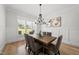 Elegant dining room featuring a wood table, decorative chandelier, wainscoting, and natural light at 20 Delia Ln, Pittsboro, NC 27312