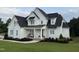 Beautiful two-story home featuring a large front yard and inviting front porch at 20 Delia Ln, Pittsboro, NC 27312