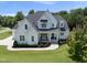 Stunning two-story home with a landscaped lawn, elegant porch, and modern farmhouse design at 20 Delia Ln, Pittsboro, NC 27312