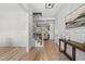 Inviting foyer with hardwood floors, white wainscoting, staircase, and view into living room at 20 Delia Ln, Pittsboro, NC 27312
