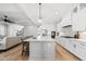 Bright, open kitchen featuring an island, stainless appliances, and white cabinetry for a modern culinary experience at 20 Delia Ln, Pittsboro, NC 27312