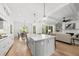 Open concept kitchen features an island with white countertops, and views into the dining room and living area at 20 Delia Ln, Pittsboro, NC 27312