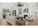 Cozy living room with a fireplace, ceiling fan, and access to the screened in porch for relaxation at 20 Delia Ln, Pittsboro, NC 27312