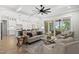 Inviting living room with a large ceiling fan, comfortable seating, and screened porch access at 20 Delia Ln, Pittsboro, NC 27312
