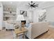 Well-lit living room with a fireplace, ceiling fan, and built-in shelving, perfect for entertaining at 20 Delia Ln, Pittsboro, NC 27312