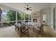 Inviting screened porch with a brick fireplace, ceiling fan and comfortable seating area overlooking a wooded backyard at 20 Delia Ln, Pittsboro, NC 27312