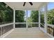 Relaxing screened porch with black railings offering views of the green backyard at 20 Delia Ln, Pittsboro, NC 27312