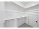 A walk-in closet with custom shelving, hardwood poles, carpeted floor and neutral colors at 20 Delia Ln, Pittsboro, NC 27312