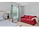 Comfortable bedroom with neutral walls, carpet, natural light, and a couch for extra seating at 200 Woodvale Way, Fuquay Varina, NC 27526