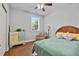 Comfortable bedroom features hardwood floors, neutral walls, a ceiling fan, and a window for natural light at 200 Woodvale Way, Fuquay Varina, NC 27526