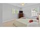 Bedroom featuring a bed, ceiling fan, carpet, dresser, and windows at 200 Woodvale Way, Fuquay Varina, NC 27526