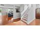 Bright entryway features hardwood floors, stairs to the upper level, and views into the living room at 200 Woodvale Way, Fuquay Varina, NC 27526