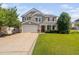 Charming two-story home featuring a welcoming front porch and attached two-car garage at 200 Woodvale Way, Fuquay Varina, NC 27526