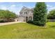 Well-maintained two-story home with a lush green lawn and mature trees at 200 Woodvale Way, Fuquay Varina, NC 27526