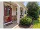 Inviting front porch with stone accents and a decorative glass front door at 200 Woodvale Way, Fuquay Varina, NC 27526