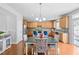 Inviting kitchen and dining area with wooden cabinets, stainless steel appliances, and backyard access at 200 Woodvale Way, Fuquay Varina, NC 27526