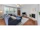 Comfortable living room featuring hardwood floors, a fireplace, and a built-in bookcase at 200 Woodvale Way, Fuquay Varina, NC 27526