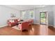 Cozy living room featuring hardwood floors, ample natural light, and comfortable seating at 200 Woodvale Way, Fuquay Varina, NC 27526
