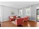 Comfortable living room with hardwood floors, large windows, and neutral paint at 200 Woodvale Way, Fuquay Varina, NC 27526
