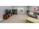 Versatile loft space with carpet, desk, television, and a comfortable couch for relaxing or entertaining at 200 Woodvale Way, Fuquay Varina, NC 27526