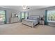 Spacious main bedroom suite with natural light, a ceiling fan, and a comfortable sitting area at 200 Woodvale Way, Fuquay Varina, NC 27526