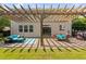 Backyard patio with pergola, string lights, seating, and a dining area, perfect for outdoor enjoyment at 200 Woodvale Way, Fuquay Varina, NC 27526