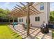 Wide angle view of a covered patio with a wooden pergola and outdoor furniture at 200 Woodvale Way, Fuquay Varina, NC 27526