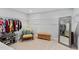 Spacious walk-in closet featuring ample shelving, seating area and a full-length mirror at 200 Woodvale Way, Fuquay Varina, NC 27526