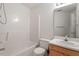 Bathroom featuring a tub/shower combo, white vanity, and modern fixtures at 205 Mint Hill Dr, Cary, NC 27519