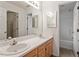 Bathroom with double sinks, a large mirror, and a doorway to a shower/tub combo at 205 Mint Hill Dr, Cary, NC 27519
