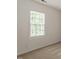 Bedroom featuring neutral carpet and paint with a large window allowing natural light at 205 Mint Hill Dr, Cary, NC 27519