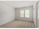 Bright bedroom with two windows, neutral carpet, and a closet with white sliding doors at 205 Mint Hill Dr, Cary, NC 27519