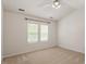 Well-lit bedroom with vaulted ceiling, two windows, and neutral carpet and paint at 205 Mint Hill Dr, Cary, NC 27519