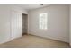 Bedroom with neutral carpet, a closet, and a window providing natural light at 205 Mint Hill Dr, Cary, NC 27519