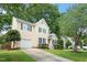 Exterior view of the home featuring an attached garage, well-maintained lawn, and traditional architecture at 205 Mint Hill Dr, Cary, NC 27519