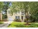 Charming two-story home features a manicured lawn, inviting entrance, and attached garage at 205 Mint Hill Dr, Cary, NC 27519