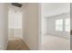 Bright hallway leading to a bedroom with two windows and neutral carpet and paint at 205 Mint Hill Dr, Cary, NC 27519