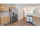 Kitchen with stainless steel refrigerator, dishwasher, and tile flooring at 205 Mint Hill Dr, Cary, NC 27519