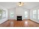 Bright living room with hardwood floors, fireplace, many windows and ceiling fan at 205 Mint Hill Dr, Cary, NC 27519